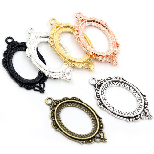 ornate oval cabochon pendant frames arranged together on a white background