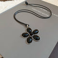 Black Flower Oval Cabochon Pendant Cord Necklace Silver Frame view 6
