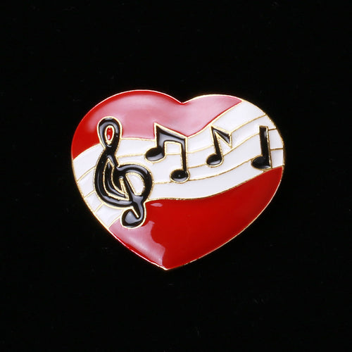 Red heart music note brooch close-up on black background