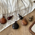 Warm Brown Double Gourd Wood Pendant Necklace on Black Cord view 2