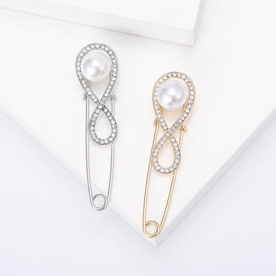 Front view of the infinity loop pearl safety pin brooch in silver and gold brooch and its color options