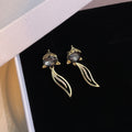 Black Faceted Top Gold Wavy Leaf Outline Dangle Earrings view 3
