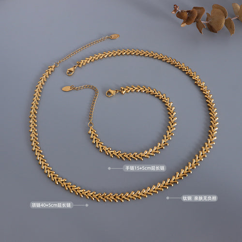 Gold chevron necklace and bracelet flat lay with length and titanium labels