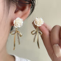 White Rose and Clear Stone Gold Tone Bow Dangle Earrings view 1