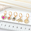 Gold Tone Crystal Heart, Lightning, Eye and Hamsa Huggie Earrings view 5