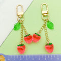 Strawberry Charm Keychains Featuring Magenta Strawberry Across 15 Pictured Variations view 4