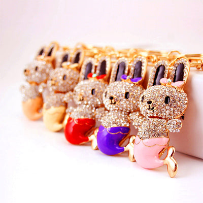 Six bunny mermaid keychains are arranged in a row with different colored tails.