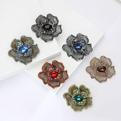 Front product view of the striped petal flower brooch on a light background