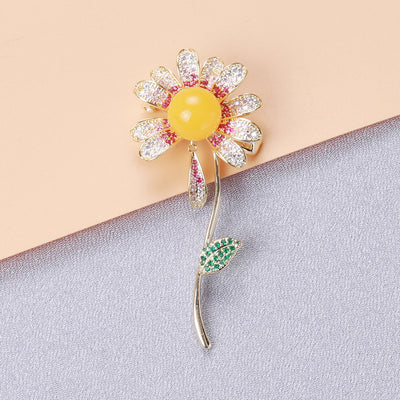 Product display showing a clear crystal daisy with a colored center and curved leafy stem