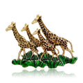 Three Giraffes Enamel Brooch Walking Across Green Grass view 1