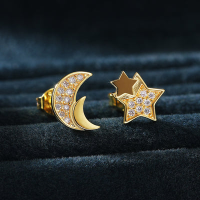 Gold crescent moon and star crystal studs on dark blue velvet