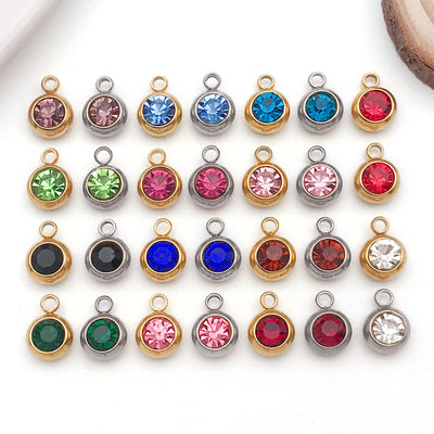 Metallic assorted shape charms arranged on a light background