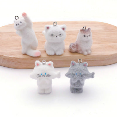 Multicolor cat keychains arranged on a light background