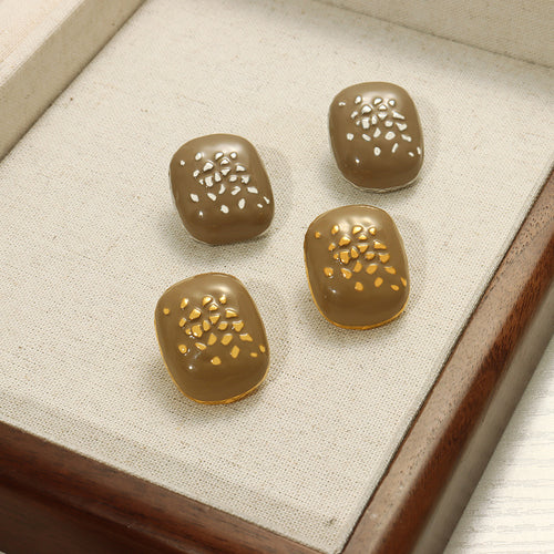 Four taupe enamel square studs gold and silver edges in tray