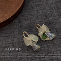 Gold Tone Oval Loop White Flower Green Leaf Iridescent Drop Earrings view 4