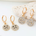 Gold Tone Crystal Smile and Frown Medallion Huggie Earrings view 1