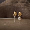 Gold Tone Pleated Top And Asymmetric White Pearl Drop Earrings view 3