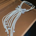 White Pearl Look Bow Necklace with Layered Tassel Strands view 1