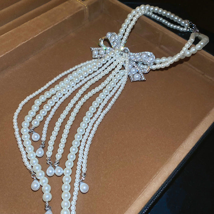 White Pearl Look Bow Necklace with Layered Tassel Strands