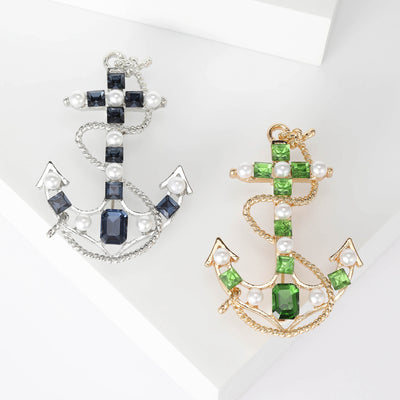 Front product view of the checkered enamel anchor brooch on a light background