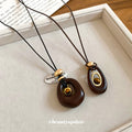 Brown Oval Layered Pendant Necklace On Black Cord Pendant Jewelry view 4