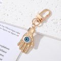 Gold and Silver Tone Geometric Hamsa and Eye Clip Keychains view 6
