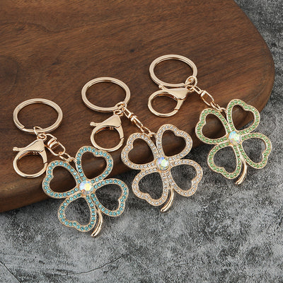 Four rhinestone clover keychains in multiple colors