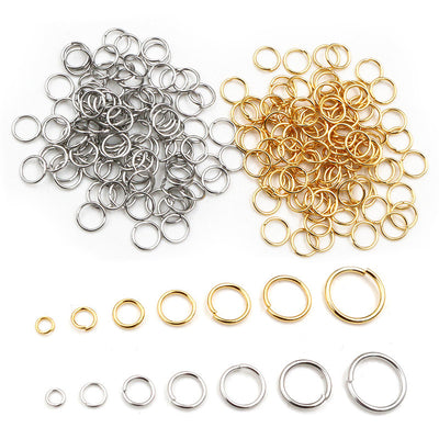 Front overview of open jump rings in graduated sizes and two metal tones arranged on a light background