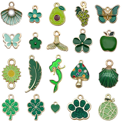 Green four-leaf clover and mushroom charms arranged on a light background