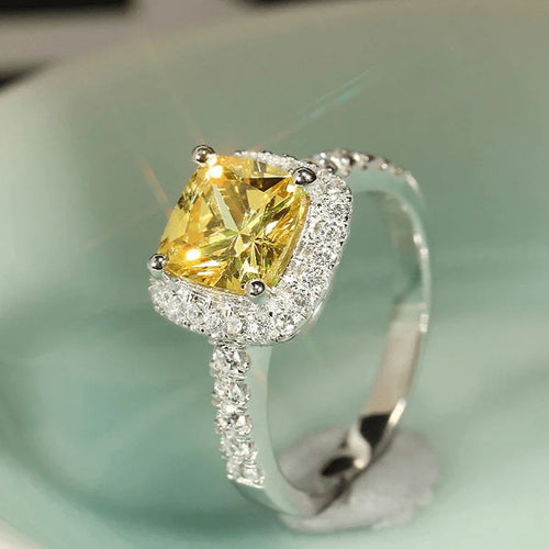 Product view showing silver-tone yellow cushion solitaire halo ring