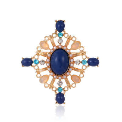 Front product view of the cross brooch pin in gold and blue