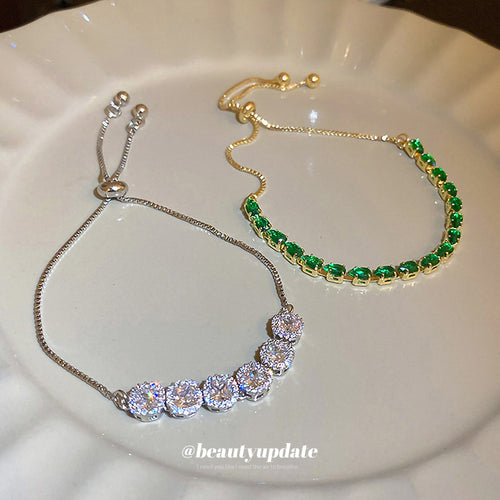two slider bracelets with green stones or silver-tone crystal clusters shown in the first close product view