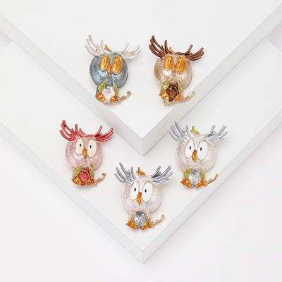 Product display showing a wide-eyed owl with spread feather tufts and colored enamel