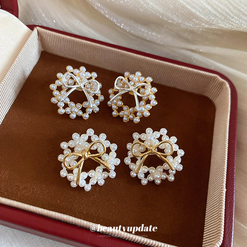 displayed product view of pearl-look bow stud earrings