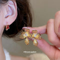 Gold Tone Red Heart And Flower Earrings With Decorative Metal Details view 2