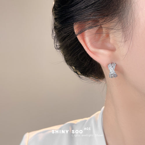 Silver X twist pave stud worn on ear side profile
