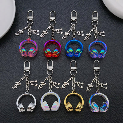 Front product photo of headphone and music note clip keychain showing the pictured design arrangement