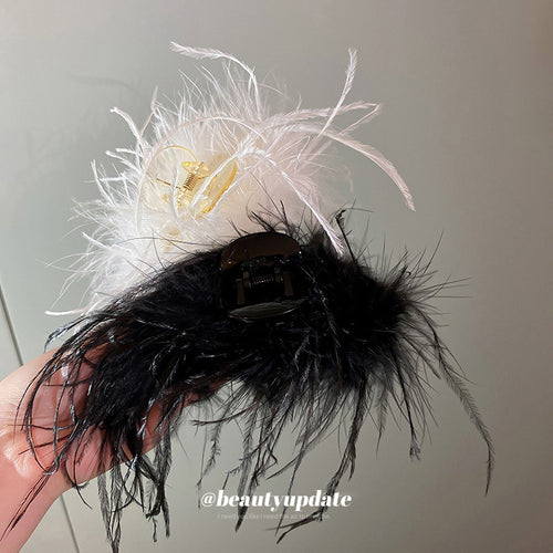 mixed assortment of seven black and white feather hair claws shown worn in a styled second view