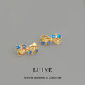Gold Tone Ribbon Bow And Bright Blue Stone Stud Earrings For Women view 6