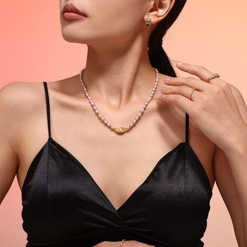 Front collarbone view of lavender pearl strand with gold pendant bead