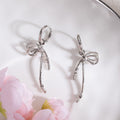 Silver Tone Ribbon Bow Long Dangle Huggie Earrings view 3