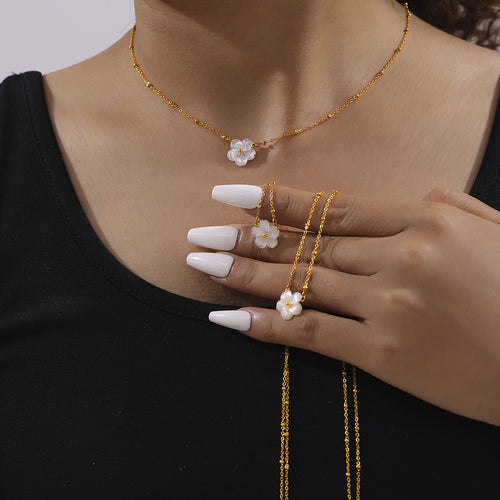 Shell flower necklace worn and two more held in hand