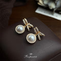 Gold Tone Clear Stone Bow And White Pearl Halo Drop Stud Earrings view 4