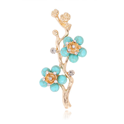 Front product view of an aqua green flower brooch