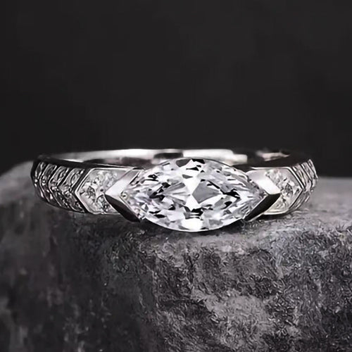 Front face of marquise clear stone ring on dark gray rock