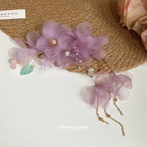 purple sheer flower duckbill hair clip with green leaf and hanging petals shown worn in a styled second view