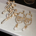 Ornate Crystal Drop Statement Earrings with Polished Metal Tone Details view 2
