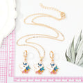 Gold Tone Glitter Unicorn Pendant Necklace and Huggie Earrings view 4