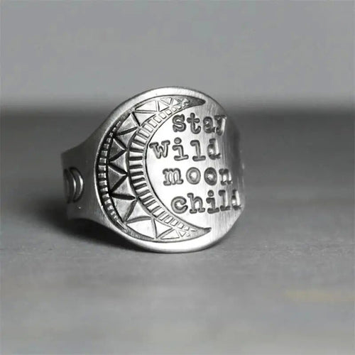 Antique silver Stay Wild Moon Child disc ring close-up on gray surface