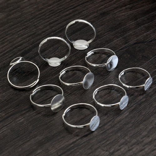 small round-pad ring blank assortment on a light background